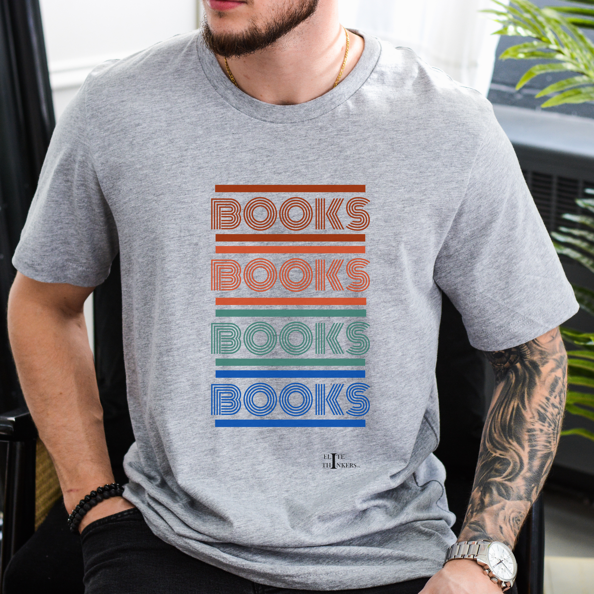 Multi-color 'books' stack on navy tee.